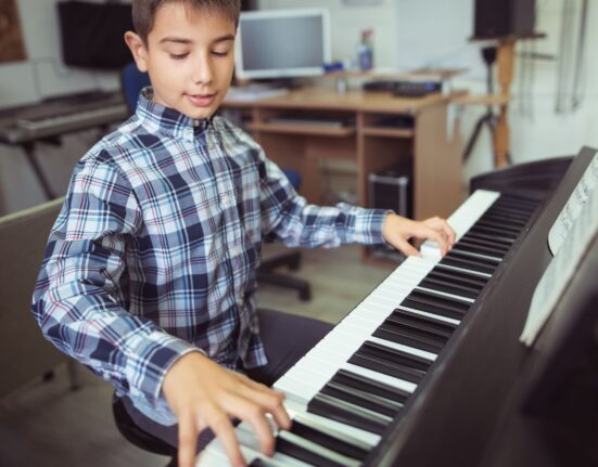A boy practicing on the piano- does practice make perfect?