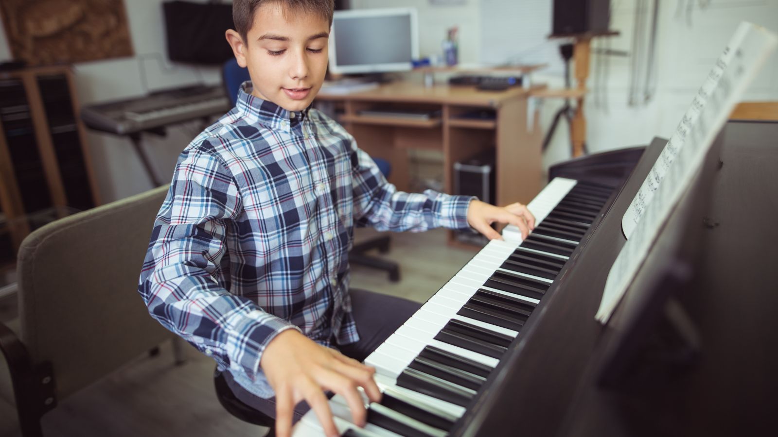 A boy practicing on the piano- does practice make perfect?