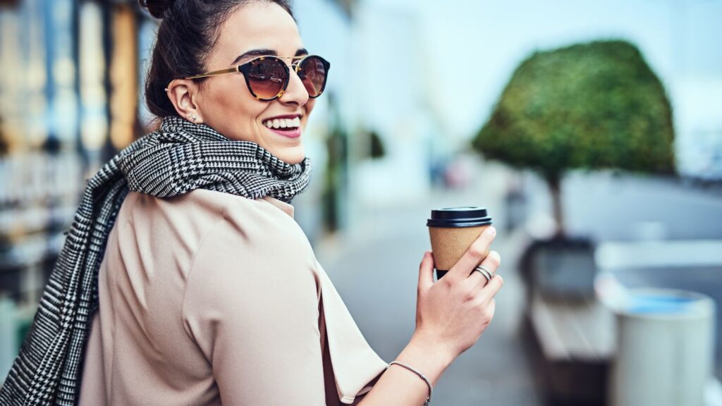 The best strokes of life- A happy girl holding a cup of coffee