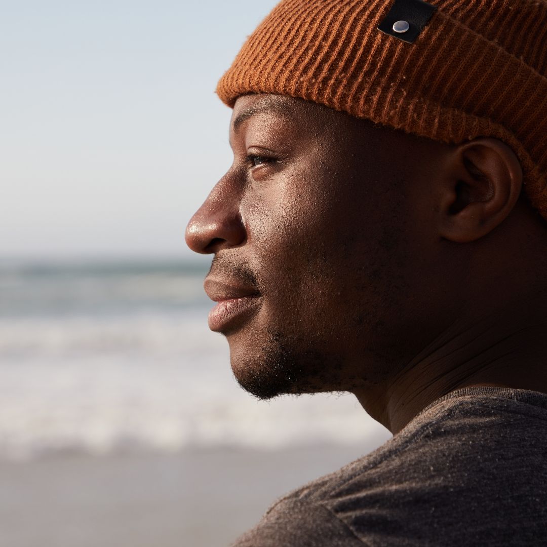 A happy man smiling at the sea