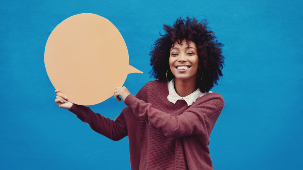Young woman holding a speech bubble to illustrate word-of-mouth marketing