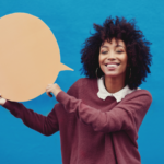 Young woman holding a speech bubble to illustrate word-of-mouth marketing