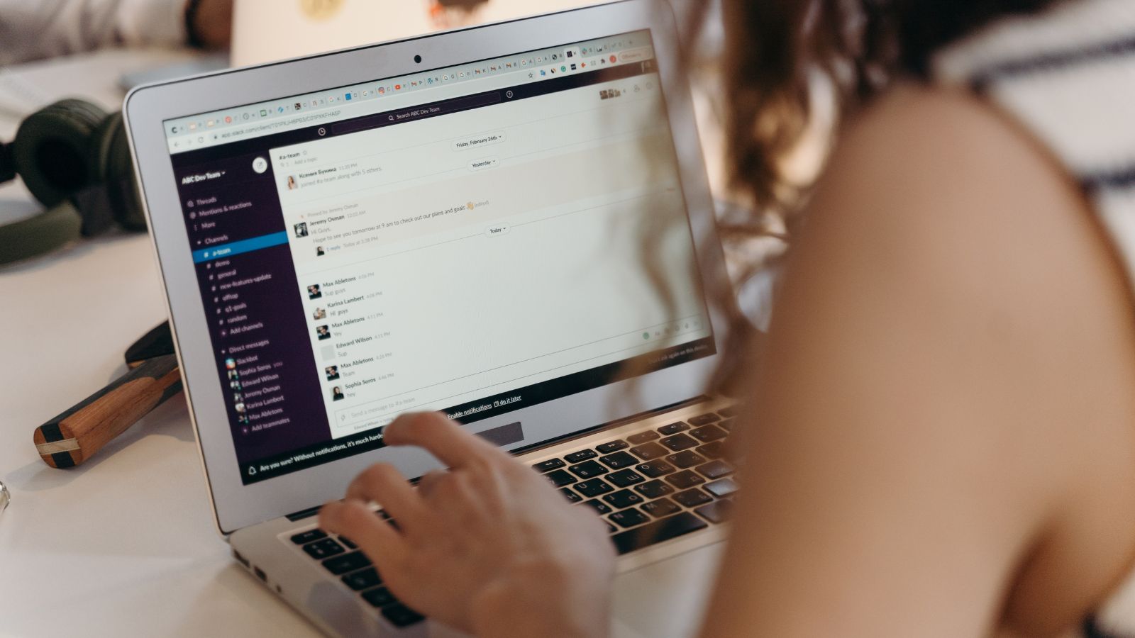 Someone using slack collaboration tool on their laptop