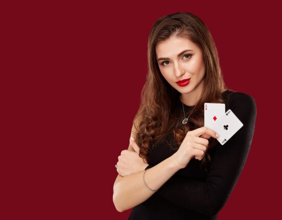 Woman in black dress holding poker cards