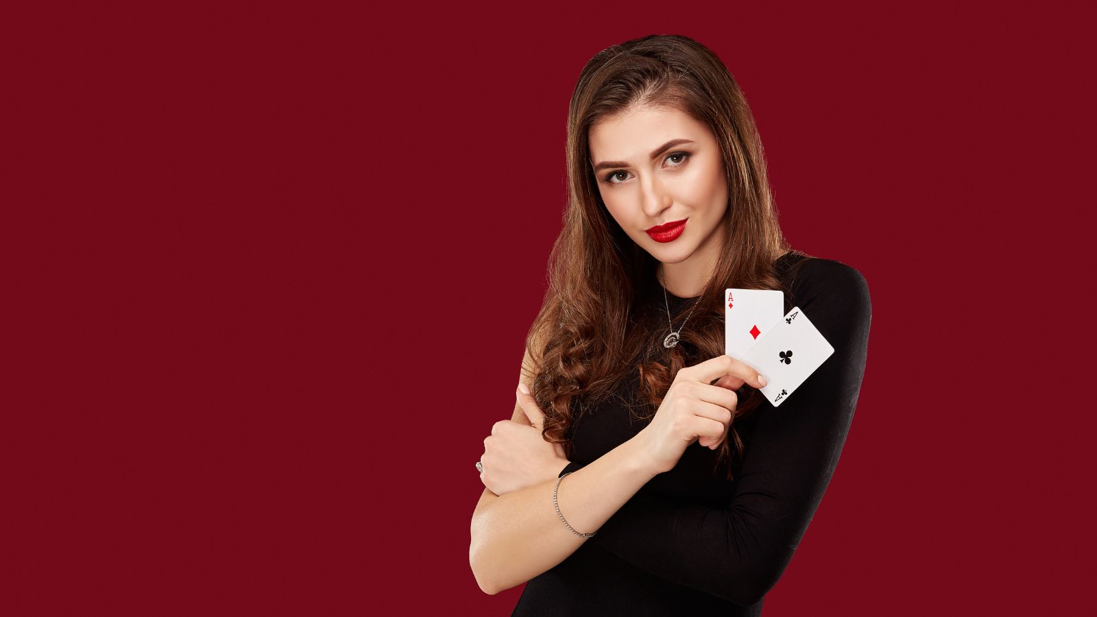 Woman in black dress holding poker cards