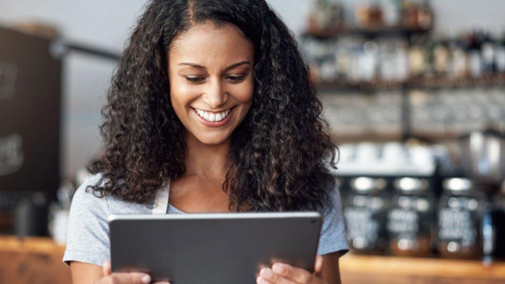 business tools - woman smiling at computer