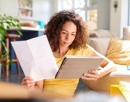 woman looking at paper - funding your business